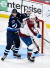 Fred Greenslade / THE CANADIAN PRESS
                                Jets centre Sean Monahan tangles with Avalanche defenceman Cale Makar Tuesday night in front of the Colorado net.