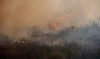Wildfires have forced thousands out of several communities in Western Canada. A wildfire burns near Flin Flon, Man., as seen from a helicopter surveying the situation, Tuesday, May 14, 2024. THE CANADIAN PRESS/David Lipnowski