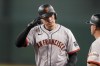 San Francisco Giants' Wilmer Flores salutes his dugout after getting a single against the Arizona Diamondbacks during the fourth inning of a baseball game Wednesday, June 5, 2024, in Phoenix. (AP Photo/Darryl Webb)