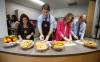 Kim Jemielity, educational assistant (from left), Prime Minister Justin Trudeau, Jenna Sudds, Minister of Families, Children and Social Development, and MP Kevin Lamoureux prepare food for students at a food program at Elwick Community School in Winnipeg, Friday. (John Woods / The Canadian Press)