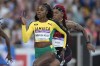 FILE - Jamaica's Elaine Thompson-Herah, center, races to win a women's 100m semifinal during the athletics in the Alexander Stadium at the Commonwealth Games in Birmingham, England, Wednesday, Aug. 3, 2022. Is trying to join Usain Bolt as only the second person to win three straight gold medals at both 100 and 200 meters. (AP Photo/Alastair Grant, File)