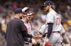 Minnesota Twins starting pitcher Bailey Ober, right, hands the ball to manager Rocco Baldelli, left, during the fifth inning of a baseball game against the Pittsburgh Pirates Sunday, June 9, 2024, in Pittsburgh. (AP Photo/Matt Freed)