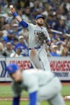 Chicago Cubs third baseman Patrick Wisdom makes a throwing error on a single by Tampa Bay Rays' Amed Rosario allowing him to advance to second base during the seventh inning of a baseball game Thursday, June 13, 2024, in St. Petersburg, Fla. (AP Photo/Christopher O'Meara)