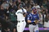 Seattle Mariners' Julio Rodríguez, left, celebrates his two-run home run next to Texas Rangers catcher Andrew Knizner during the third inning of a baseball game Saturday, June 15, 2024, in Seattle. (AP Photo/Jason Redmond)