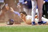 Seattle Mariners' Josh Rojas reacts after scoring before a tag by Texas Rangers starting pitcher Dane Dunning on a wild pitch in the fifth inning of a baseball game, Sunday, June 16, 2024, in Seattle. (AP Photo/John Froschauer)