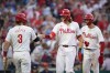 Philadelphia Phillies' Alec Bohm, center, celebrates with Bryce Harper, left, and Trea Turner after hitting a three-run home run against San Diego Padres pitcher Randy Vasquez during the fifth inning of a baseball game, Monday, June 17, 2024, in Philadelphia. (AP Photo/Matt Slocum)