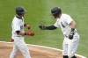 Chicago White Sox's Tommy Pham, right, greets Andrew Benintendi at home after they both scored on Benintendi's two-run home run off Los Angeles Dodgers starting pitcher Bobby Miller during the first inning of a baseball game Tuesday, June 25, 2024, in Chicago. (AP Photo/Charles Rex Arbogast)