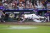Houston Astros' Cesar Salazar, right, beats the throw as he safely slides into home plate in front of Colorado Rockies catcher Jacob Stallings, left, on the RBI single by Jose Altuve during the fifth inning of a baseball game Wednesday, June 26, 2024, in Houston. (AP Photo/Michael Wyke)