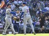 New York Mets catcher Luis Torrens, left, and pitcher Drew Smith (33) celebrate after a baseball game against the Chicago Cubs, Friday, June 21, 2024, in Chicago. (AP Photo/Matt Marton)