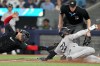 New York Yankees outfielder Juan Soto (22) slides safe into home as Toronto Blue Jays catcher Danny Jansen (9) fails to make the tag during fourth inning American League MLB baseball action in Toronto, Friday, June 28, 2024. THE CANADIAN PRESS/Chris Young