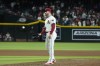 Arizona Diamondbacks relief pitcher Brandon Hughes gets a new ball after giving up a home run to Oakland Athletics' Daz Cameron during the ninth inning of a baseball game Friday, June 28, 2024, in Phoenix. The Athletics won 9-4. (AP Photo/Ross D. Franklin)