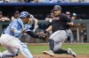 Cleveland Guardians' Josh Naylor, right, scores off a Andres Gimenez double as Kansas City Royals catcher Salvador Perez, left, is late with the tag during the fifth inning of a baseball game in Kansas City, Mo., Saturday, June 29, 2024. (AP Photo/Colin E. Braley)