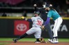 Minnesota Twins' Carlos Santana (30) is called safe at second for a double in front of the tag from Seattle Mariners shortstop J.P. Crawford, right, during the fourth inning of a baseball game Saturday, June 29, 2024, in Seattle. (AP Photo/Lindsey Wasson)