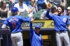 Chicago Cubs' Nico Hoerner is congratulated after hitting a home run during the first inning of a baseball game against the Milwaukee Brewers Sunday, June 30, 2024, in Milwaukee. (AP Photo/Morry Gash)