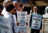 WestJet airplane mechanics stand in a the picket line at Calgary International Airport in Calgary, Saturday, June 29, 2024.THE CANADIAN PRESS/Jeff McIntosh