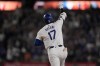 Los Angeles Dodgers designated hitter Shohei Ohtani celebrates while running the bases after hitting the go-ahead two-run home run during the seventh inning of a baseball game against the Arizona Diamondbacks, Tuesday, July 2, 2024, in Los Angeles. (AP Photo/Ryan Sun)