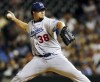 FILE - Los Angeles Dodgers relief pitcher Eric Gagne delivers a pitch to Colorado Rockies batter Preston Wilson in the ninth inning of a baseball game in Denver on Monday, July 26, 2004. Gagne won the 2007 World Series with the Red Sox during his 10-year major league career (AP Photo/David Zalubowski, File)