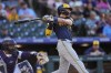 Milwaukee Brewers' Christian Yelich follows the flight of his solo home run off Colorado Rockies starting pitcher Dakota Hudson in the first inning of a baseball game, Wednesday, July 3, 2024, in Denver. (AP Photo/David Zalubowski)