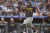 Milwaukee Brewers' Rhys Hoskins scores on a double hit by Jackson Chourio off Colorado Rockies relief pitcher Anthony Molina in the sixth inning of a baseball game Thursday, July 4, 2024, in Denver. (AP Photo/David Zalubowski)