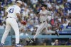Arizona Diamondbacks' Corbin Carroll, right, runs home past Los Angeles Dodgers relief pitcher Anthony Banda to score off a single hit by Ketel Marte during the fifth inning of a baseball game, Thursday, July 4, 2024, in Los Angeles. (AP Photo/Ryan Sun)