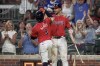 Atlanta Braves' Ozzie Albies (1) is congratulated by teammate Matt Olson, right, after hitting a home run in the sixth inning of a baseball game against the Philadelphia Phillies, Friday, July 5, 2024, in Atlanta. (AP Photo/Jason Allen)