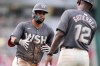 Washington Nationals second baseman Luis Garcia Jr., left, is congratulated by third base coach Ricky Gutierrez (12) after hitting a solo home run during the third inning of a baseball game against the St. Louis Cardinals at Nationals Park, Friday, July 5, 2024, in Washington. (AP Photo/Mark Schiefelbein)