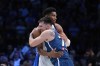 Greece's Giannis Antetokounmpo, rear, hugs Slovenia's Luka Doncic ahead of a basketball match, during the Acropolis basketball tournament at the Peace and Friendship indoor stadium at Athens' port city of Piraeus, Saturday, July 6, 2024. (AP Photo/Petros Giannak ouris)