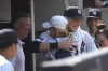 New York Yankees' Ben Rice, center right, hugs family after winning a baseball game against the Boston Red Sox, Saturday, July 6, 2024, in New York. (AP Photo/Pamela Smith)