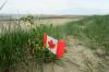 A small Canadian flag on Juno Beach on the 75th D-Day Anniversary in Courseulles-Sur-Mer, France on June 6, 2019. (Sean Kilpatrick / The Canadian Press files)
