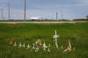 MIKE DEAL / FREE PRESS
Seventeen small white crosses are planted in a nearby ditch.