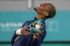 FILE - CJ Nickolas of the United States sings the national anthem after receiving a gold in men's taekwondo kyorugi -80kg at the Pan American Games in Santiago, Chile, Oct. 22, 2023. At 22, Nickolas is the highest-ranked U.S. athlete in taekwondo, No. 2 in the world in the men’s 80-kilogram (176-pound) class. A silver medalist at last year’s world championships, he will be leading the four-member U.S. taekwondo team in Paris. (AP Photo/Esteban Felix, File)