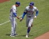 New York Mets' Brandon Nimmo (9) is greeted by third base coach Mike Sarbaugh as he rounds third base after hitting a two-run home run off Pittsburgh Pirates starting pitcher Mitch Keller during the sixth inning of a baseball game in Pittsburgh, Monday, July 8, 2024. (AP Photo/Gene J. Puskar)