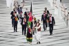 FILE - Kimia Yousofi, front left, and Farzad Mansouri, of Afghanistan, carry their country's flag during the opening ceremony in the Olympic Stadium at the 2020 Summer Olympics on July 23, 2021, in Tokyo, Japan. Afghan sprinter Yousofi is preparing to compete at her third Olympics after being selected for the Paris Games from her training base in Australia. The Australian Olympic Committee on Tuesday, July 9, 2024, congratulated Yousofi on her selection for the women's 100-meter sprint. (AP Photo/David J. Phillip, File)