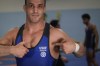 Iranian wrestler Iman Mahdavi, 28, poses at the Lotta Club Seggiano gym, in Pioltello, northern Italy, Wednesday, Feb. 28, 2024. Mahdavi fled his home country in fear of his life in October 2020. Now, he will compete in Paris as part of the Refugee Olympic Team. (AP Photo/Luca Bruno)