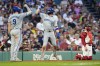 Kansas City Royals' Bobby Witt Jr. (7) celebrates after his solo home run with Vinnie Pasquantino (9) as Boston Red Sox catcher Connor Wong, right, kneels at home plate during the fourth inning of a baseball game, Friday, July 12, 2024, in Boston. (AP Photo/Michael Dwyer)