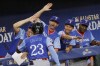 National League's Cam Collier (23) gets high-fives from former Texas Rangers Michael Young, manager for the National League team, third from right, and his teammates after hitting a home run during the third inning of the MLB All-Star Futures baseball game against the American League team Saturday, July 13, 2024, in Arlington, Texas. (Chitose Suzuki/The Dallas Morning News via AP)
