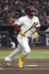 Arizona Diamondbacks' Joc Pederson watches his RBI double against the Toronto Blue Jays in the first inning during a baseball game, Saturday, July 13, 2024, in Phoenix. (AP Photo/Rick Scuteri)
