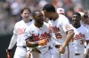Baltimore Orioles' Cedric Mullins (31) celebrates with Anthony Santander (25) after Mullins hit a two RBI walk-off double to win a baseball game against the New York Yankees, Sunday, July 14, 2024, in Baltimore. The Orioles won 6-5. (AP Photo/Nick Wass)