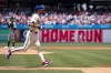 Philadelphia Phillies' Trea Turner, right, rounds the bases after hitting a solo home run against Oakland Athletics starting pitcher Joey Estes, left, during the first inning of a baseball game, Sunday, July 14, 2024, in Philadelphia. (AP Photo/Chris Szagola)