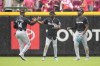 Miami Marlins' Bryan De La Cruz (14) celebrates with teammates Nick Gordon, center, and Jesús Sánchez following the team's victory over the Cincinnati Reds, Sunday, July 14, 2024, in Cincinnati. (AP Photo/Jeff Dean)