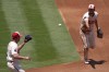 Los Angeles Angels first baseman Nolan Schanuel, right, tosses the ball to starting pitcher Carson Fulmer to force out Seattle Mariners' Victor Robles at first during the third inning of a baseball game Sunday, July 14, 2024, in Anaheim, Calif. (AP Photo/Mark J. Terrill)