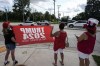 Supporters await former President Donald Trump's airport arrival ahead of the 2024 Republican National Convention, Sunday, July 14, 2024, in Milwaukee. (AP Photo/Alex Brandon)