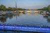 FILE - Athletes dive into the Seine River from the Alexander III bridge on the start of the first leg of the women's triathlon test event for the 2024 Paris Olympics in Paris, Aug. 17, 2023. (AP Photo/Michel Euler, File)