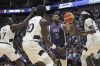 United States' forward LeBron James, (6), reaches for the ball under pressure from South Sudan's forward Nuni Omot, right, South Sudan's forward JT Thor, (10), and South Sudan's guard Bul Kuol, left, during an exhibition basketball game between the United States and South Sudan, at the o2 Arena in London, Saturday, July 20, 2024. (AP Photo/Kin Cheung)