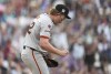 San Francisco Giants starting pitcher Logan Webb reacts after giving up a two-run home run to Colorado Rockies' Ezequiel Tovar in the fifth inning of a baseball game Saturday, July 20, 2024, in Denver. (AP Photo/David Zalubowski)