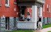 Workers enter Stratford Hall, an apartment residence in north Winnipeg on Monday, July 22, 2024. The new landlord evicted residents last week and the province has taken over and is allowing residents to re-enter the building. THE CANADIAN PRESS/John Woods