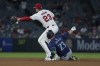 Seattle Mariners' Ty France (23) is forced out on a throw to Los Angeles Angels second baseman Brandon Drury (23) during the seventh inning of a baseball game in Anaheim, Calif., Thursday, July 11, 2024. (AP Photo/Eric Thayer)