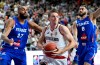 Germany's Justus Hollatz is challenged by France's Rudy Gobert, left, and Isaiah Cordinier duirng their international match at the Lanxess Arena, Cologne, Germany, Saturday July 6, 2024. (Roberto Pfeil/dpa via AP)