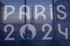 FILE - The Eiffel Tower is seen behind a Paris Olympics canvas, from the Trocadero plaza Thursday, July 18, 2024 in Paris. (AP Photo/David Goldman, File)