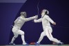 Hungary's Aron Szilagyi, left, and Canada's Fares Arfa compete in the men's individual Sabre round of 32 competition during the 2024 Summer Olympics at the Grand Palais, Saturday, July 27, 2024, in Paris, France. (AP Photo/Andrew Medichini)